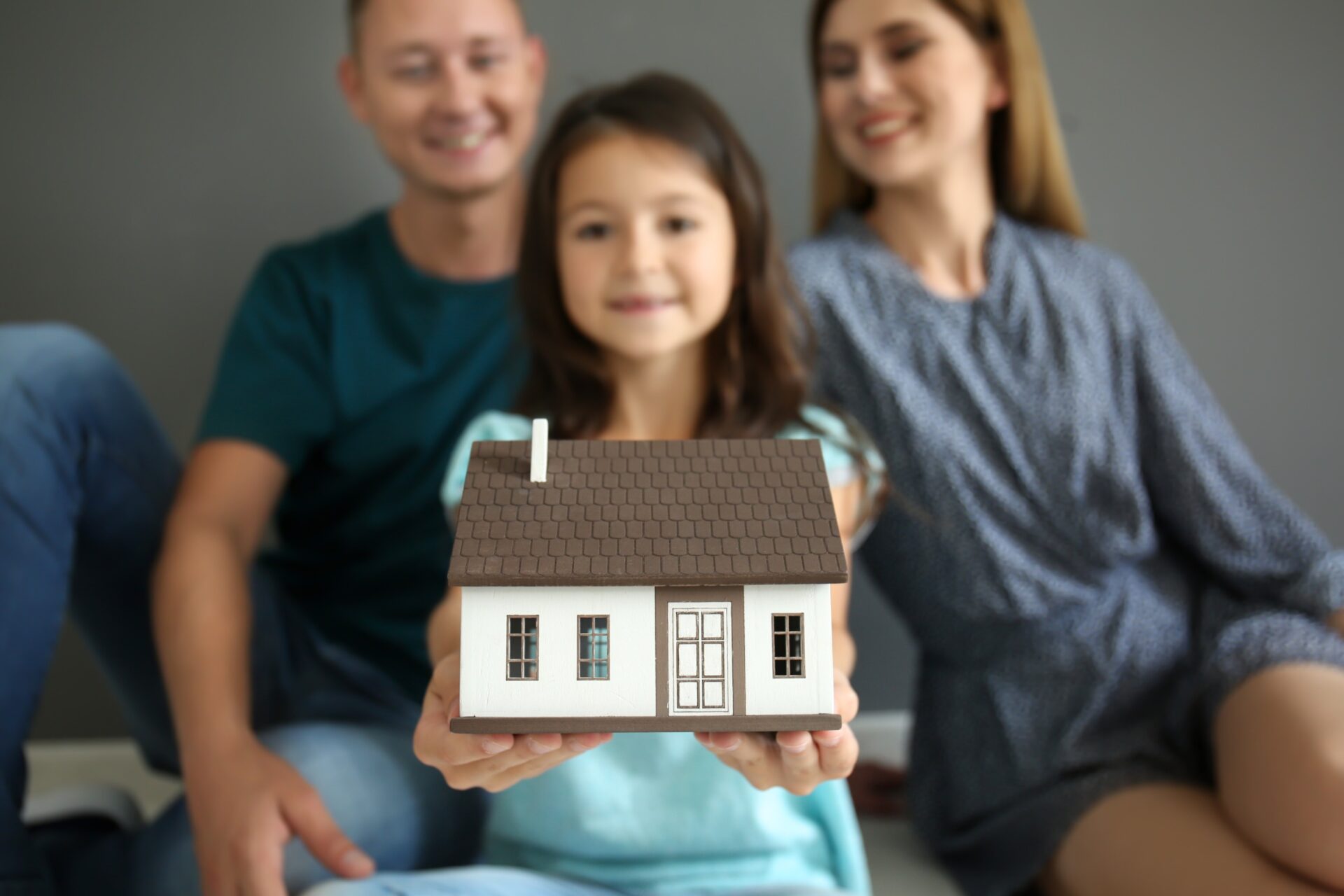 family holding a model home